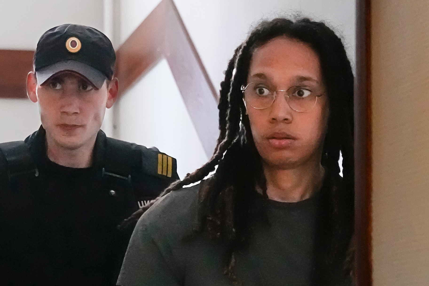 Brittney Griner is escorted to a courtroom for a hearing