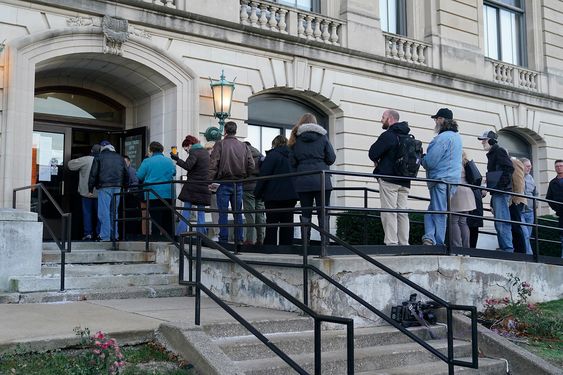 People wait to enter the Carroll County Courthouse