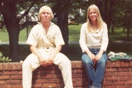 John Moxley and Martha Moxley sitting on a brick wall.