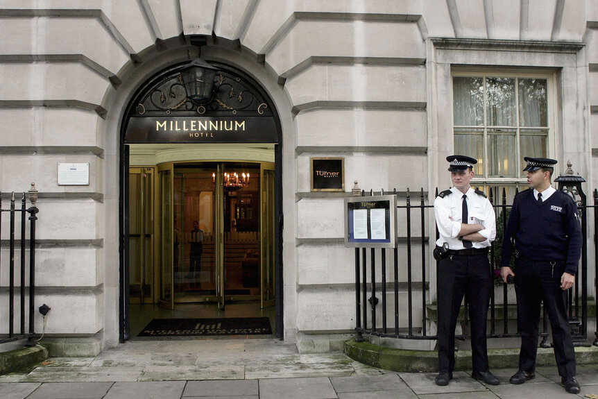 Two British police officers stand outside of the Millennium Hotel