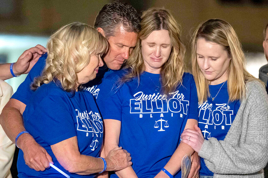 he wife of Elliot Blair is comforted by her family
