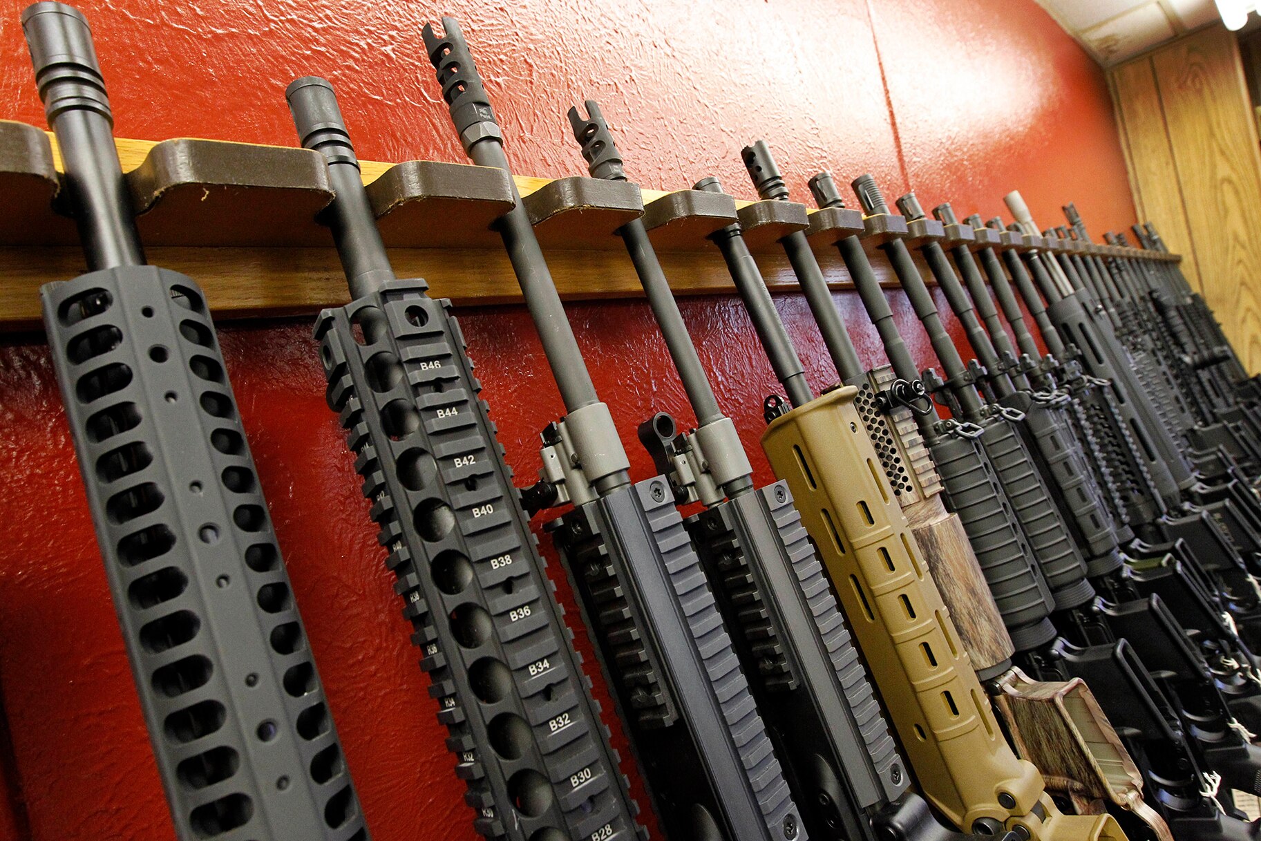 A row of different AR-15 style rifles are displayed for sale