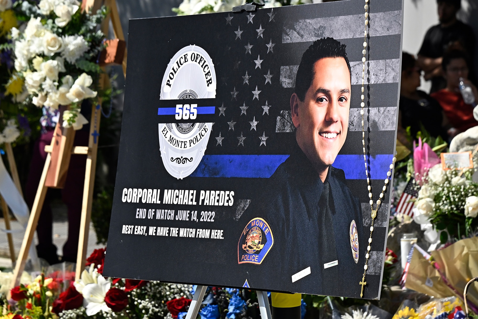 Corporal Michael Paredes in front of a makeshift memorial
