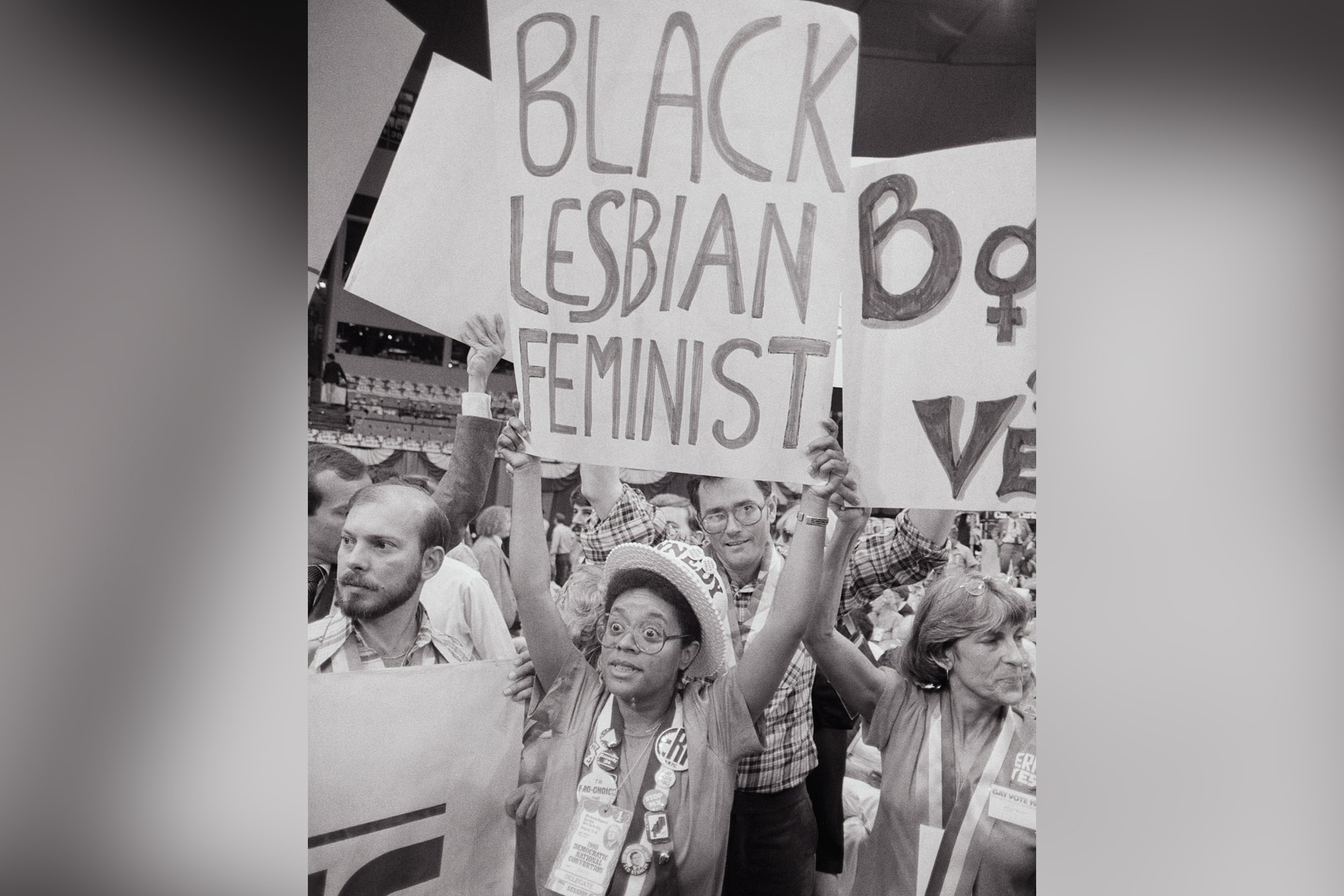 Gwenn Craig, of San Francisco, CA, holds aloft a poster reading 'Black Lesbian Feminist'