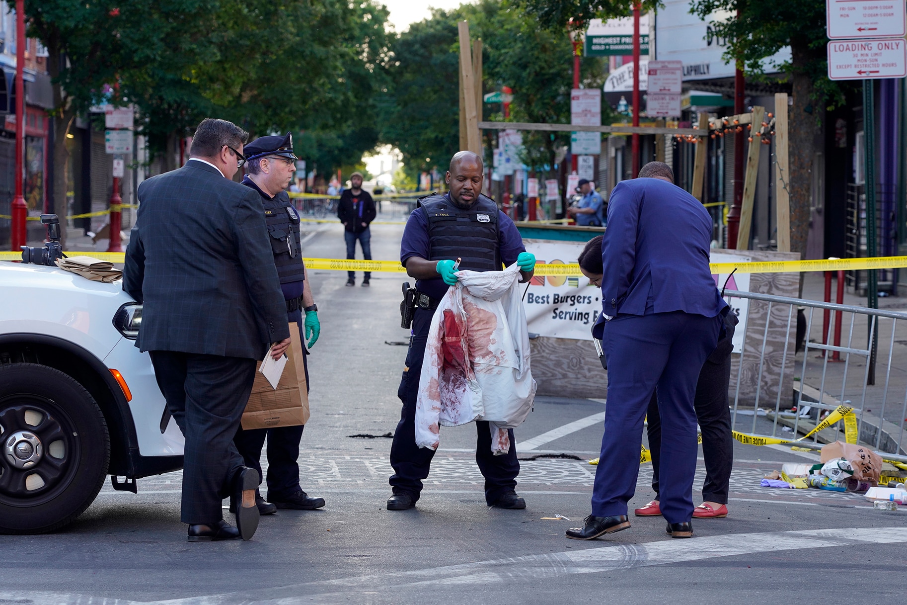 investigators on the scene of the shooting on South Street in Philadelphia