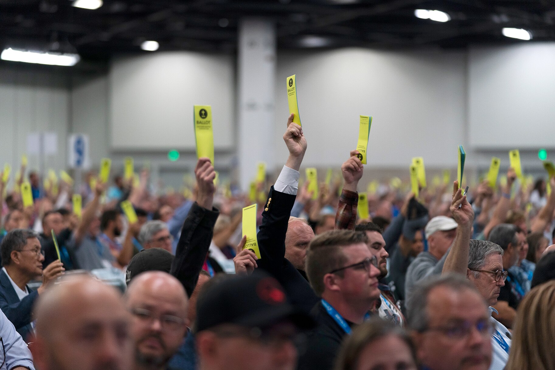 Attendees hold up their ballots during a session at the Southern Baptist Convention's annual meeting