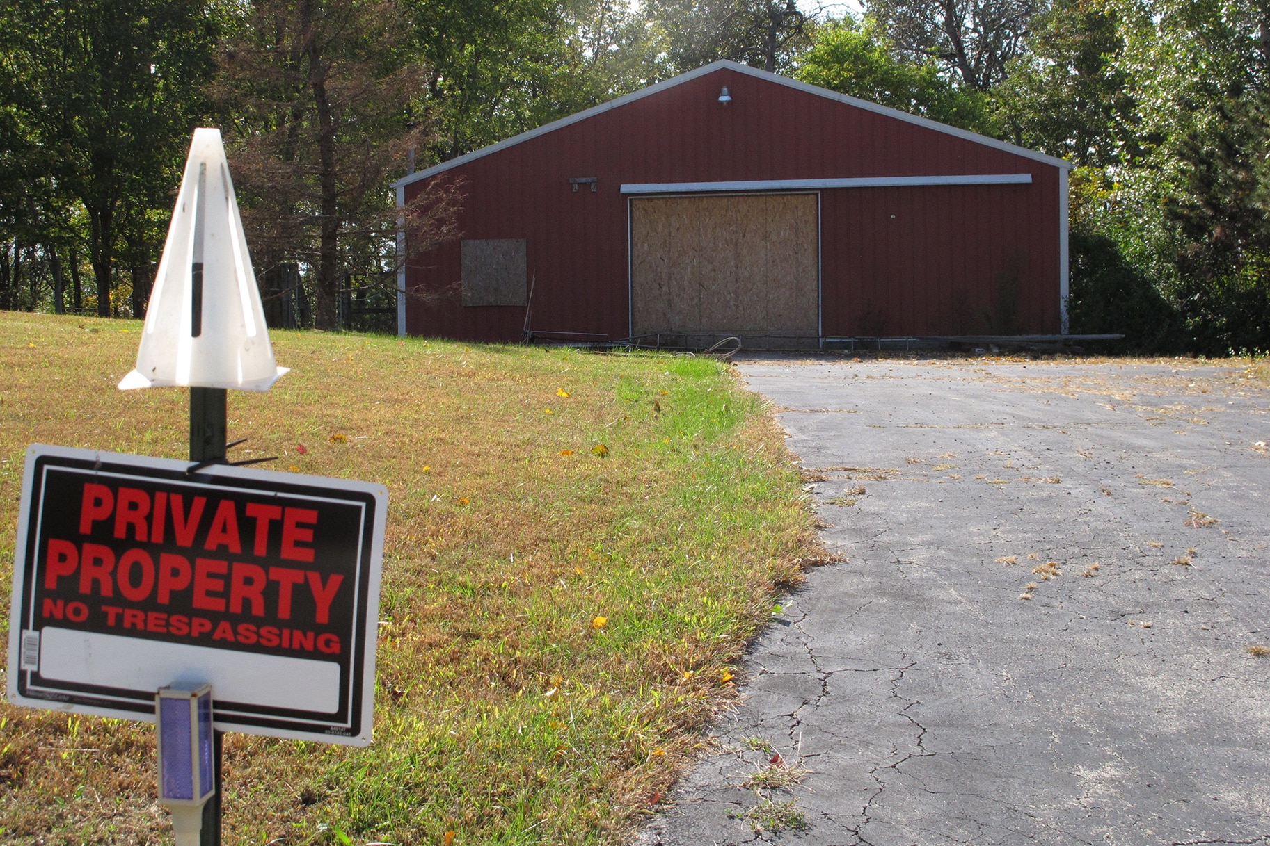 A private property sign guards the boarded up garage on property on Union Hill Road