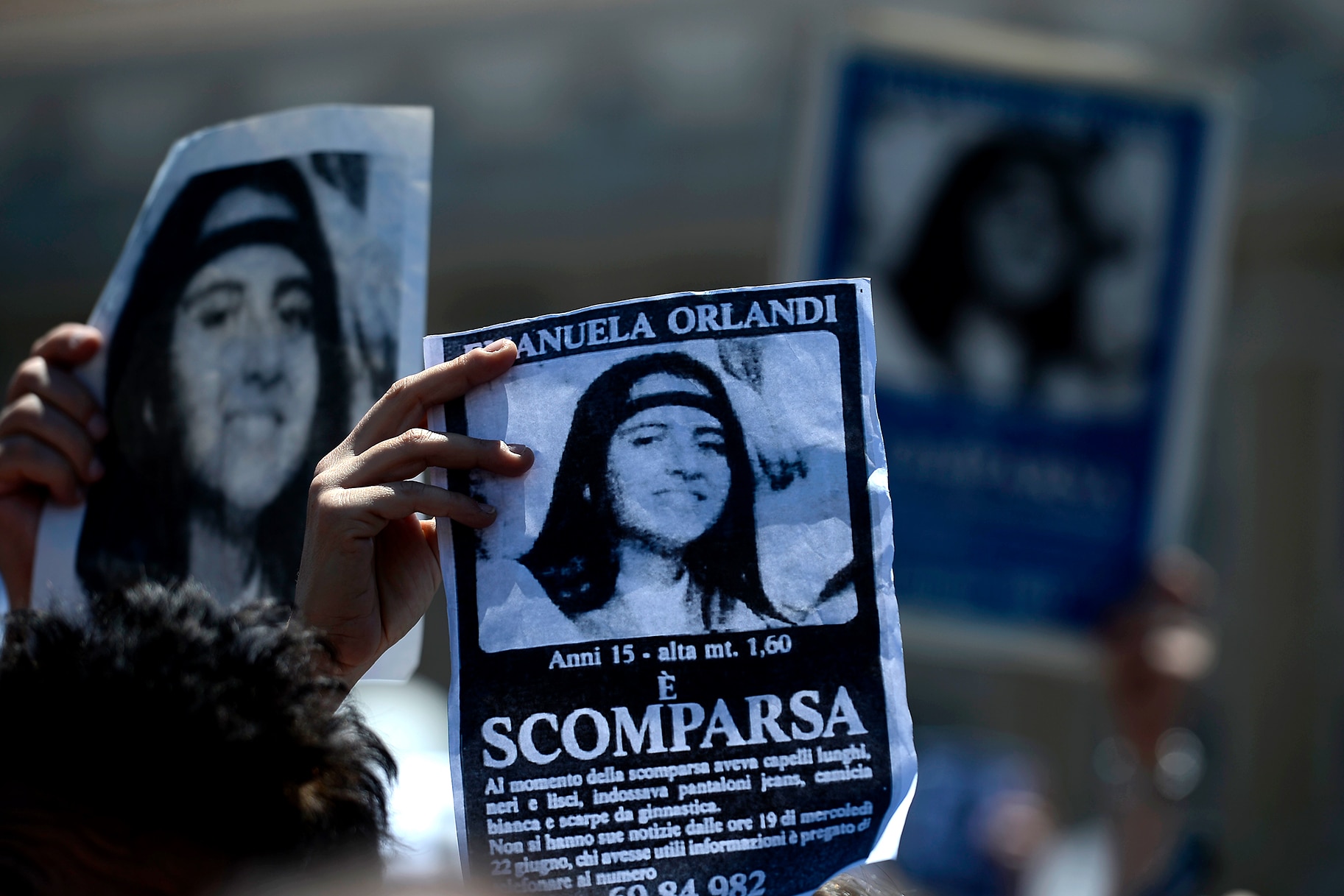 A demonstrator holds a poster of Emanuela Orlandi