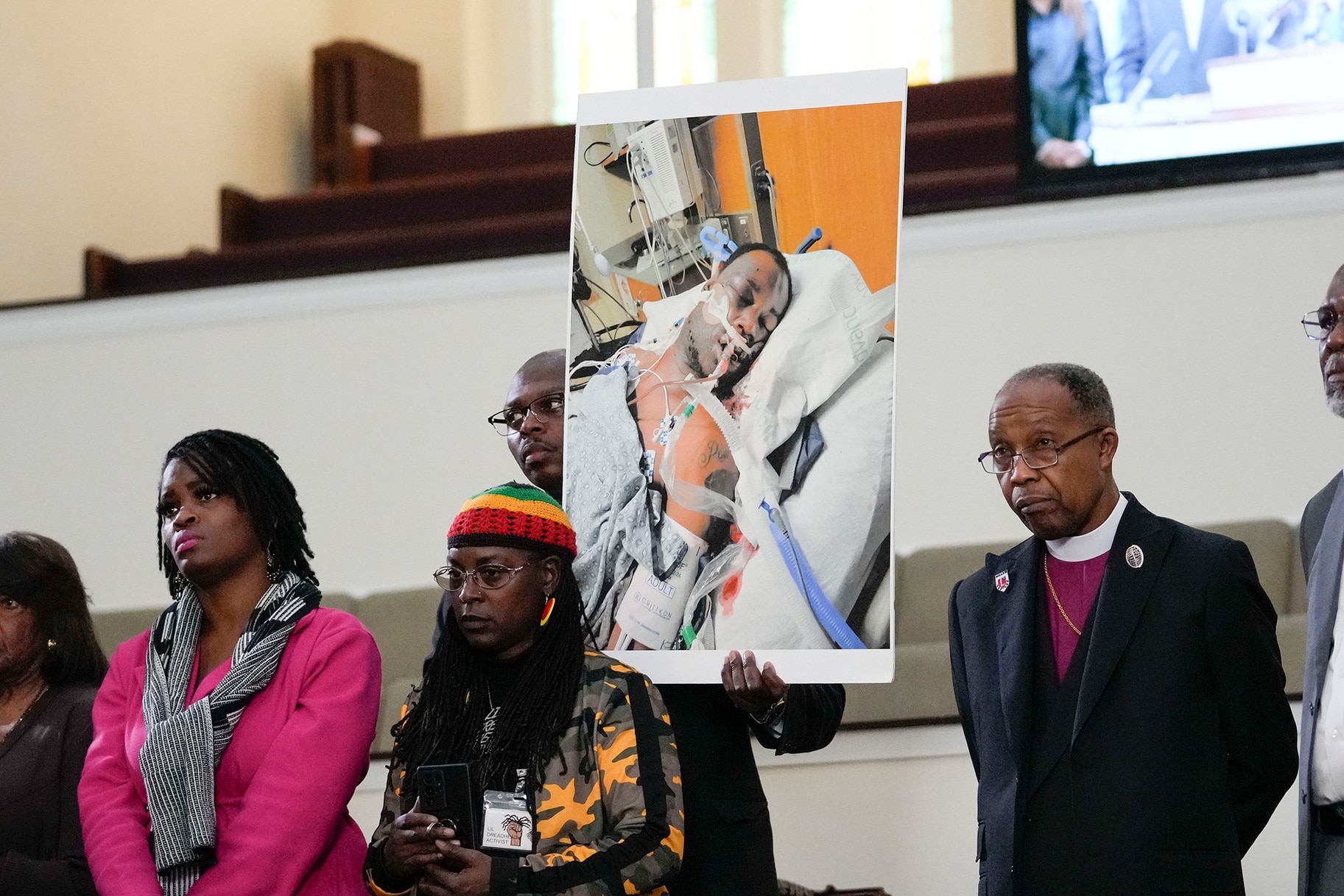 Family members and supporters hold a photograph of Tyre Nichols
