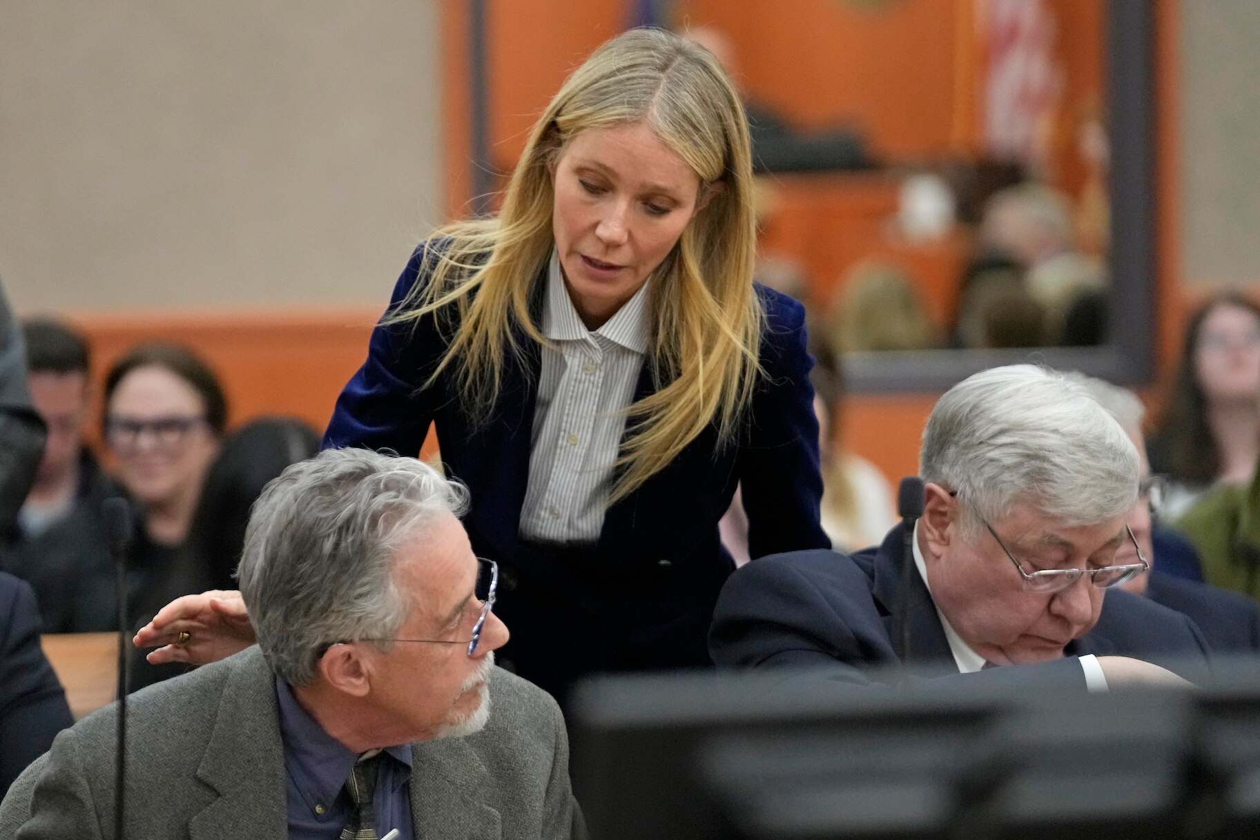 Gwyneth Paltrow taps Terry Sanderson on the shoulder in court.