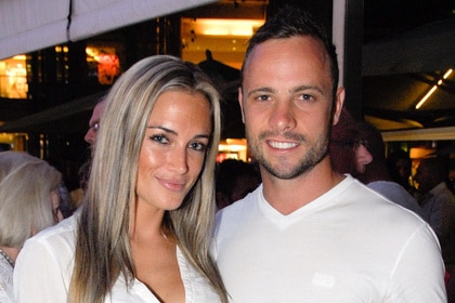 Reeva Steenkamp and Oscar Pistorius smile together in white shirts