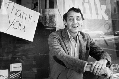 Harvey Milk sits outside his camera shop in San Francisco, November 9, 1977.