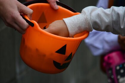 A Trick Or Treater grabbing candy