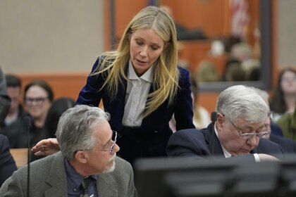 Gwyneth Paltrow taps Terry Sanderson on the shoulder in court.