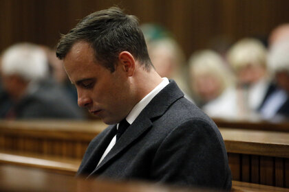 Oscar Pistorius puts his head down in court
