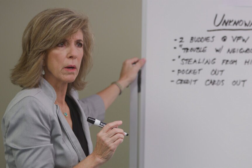 Kelly Siegler writes on a whiteboard in the war room on Cold Justice Episode 701