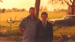 Michael Ryan And Son Dennis Stand In the Sunlight