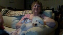 Jacquaeline “Jackie” Z. Williams posing on couch with a dog.