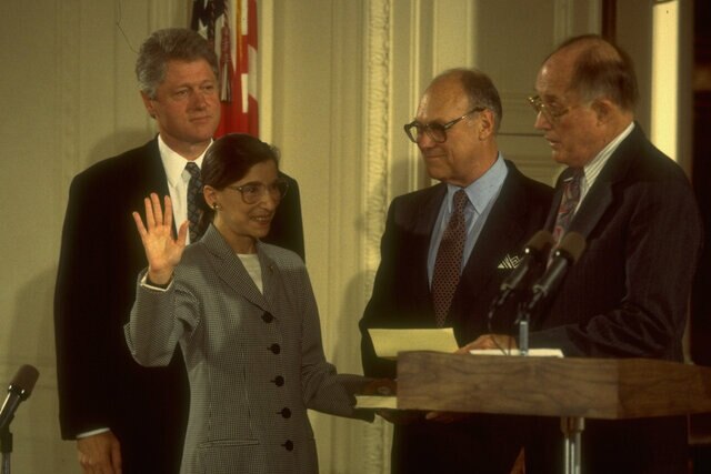 Supreme Court Chief Justice William Rehnquist (R) swearing in new justice Ruth Bader Ginsburg as husband Martin & Pres. Bill Clinton (L) look on.