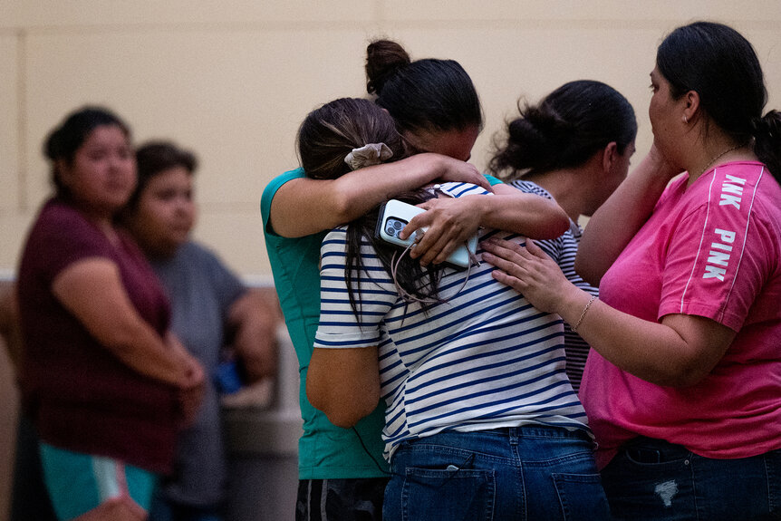 People mourn outside of the SSGT Willie de Leon Civic Center following the mass shooting at Robb Elementary School