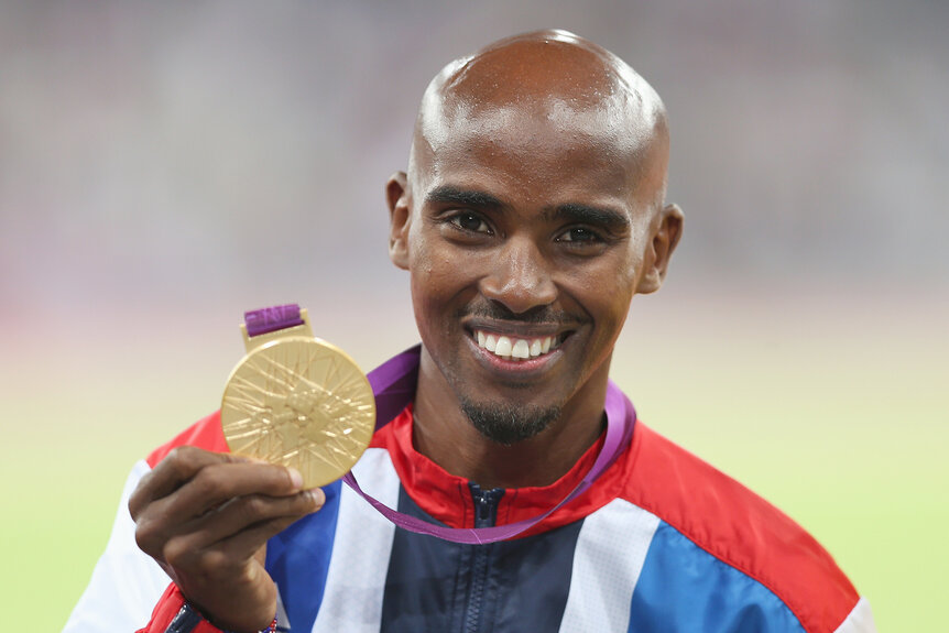 Gold medalist Mohamed Farah of Great Britain poses on the podium