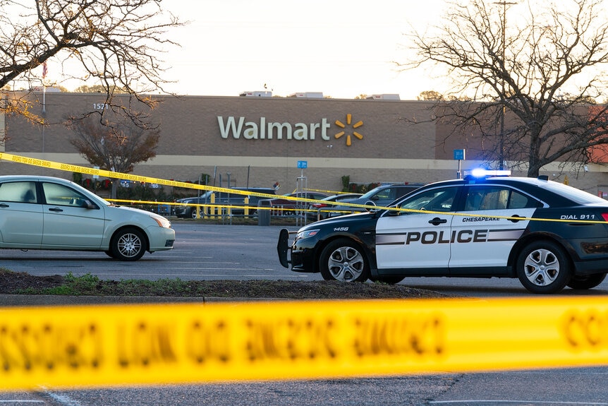 Law enforcement work the scene of a mass shooting at a Walmart