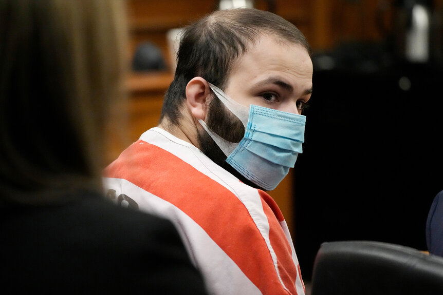 Ahmad Al Aliwi Alissa, wearing a mask and a prison uniform, listens during a hearing