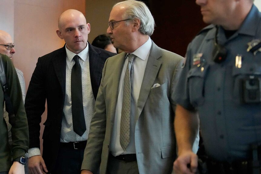 Jason Rosenblatt walks with his lawyer leaving the courtroom