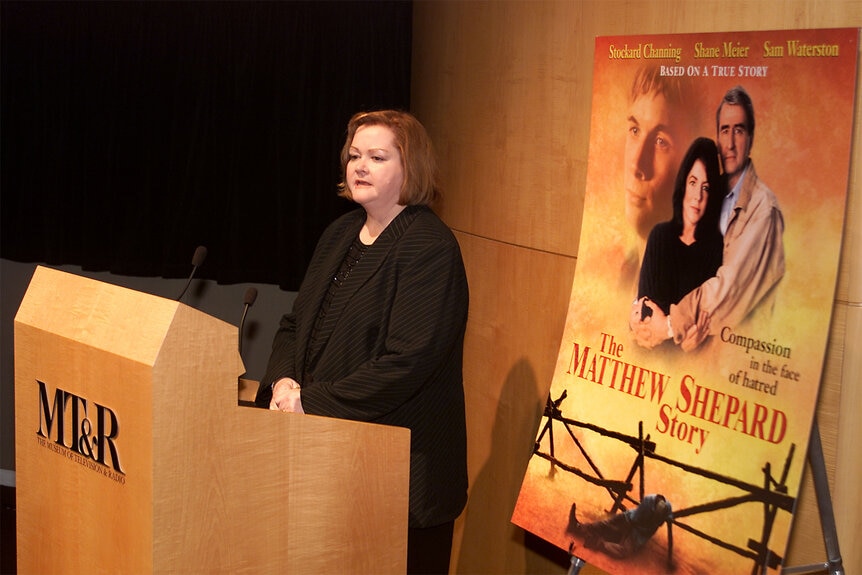 Mathew Shepard's mother Judy Shepard stands at a podium