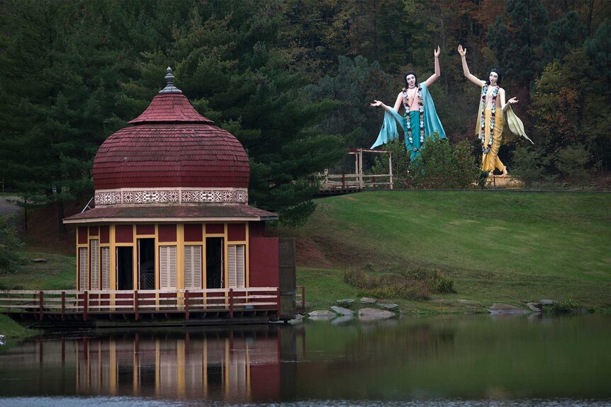 Statues that look like they are dancing on the lawn in the New Vrindaban Community