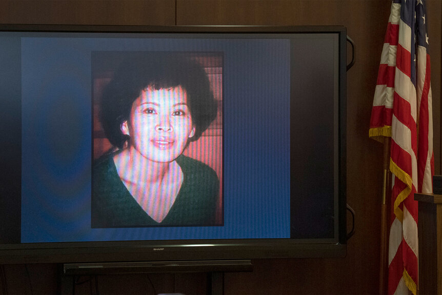 A photo of Micki Kanesaki is put up on a screen in court